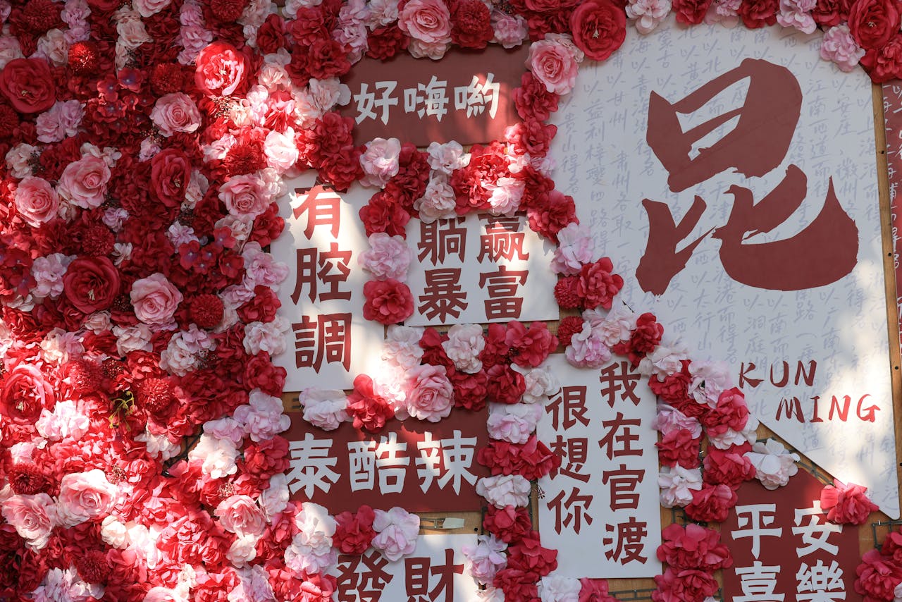 Decorative floral wall featuring Chinese characters and signs in vivid red and pink hues.